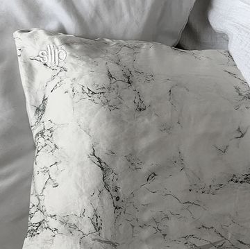 marble slip silk pillowcase on bed with white duvet cover