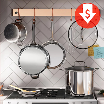 stainless steel cookware set hanging above stove